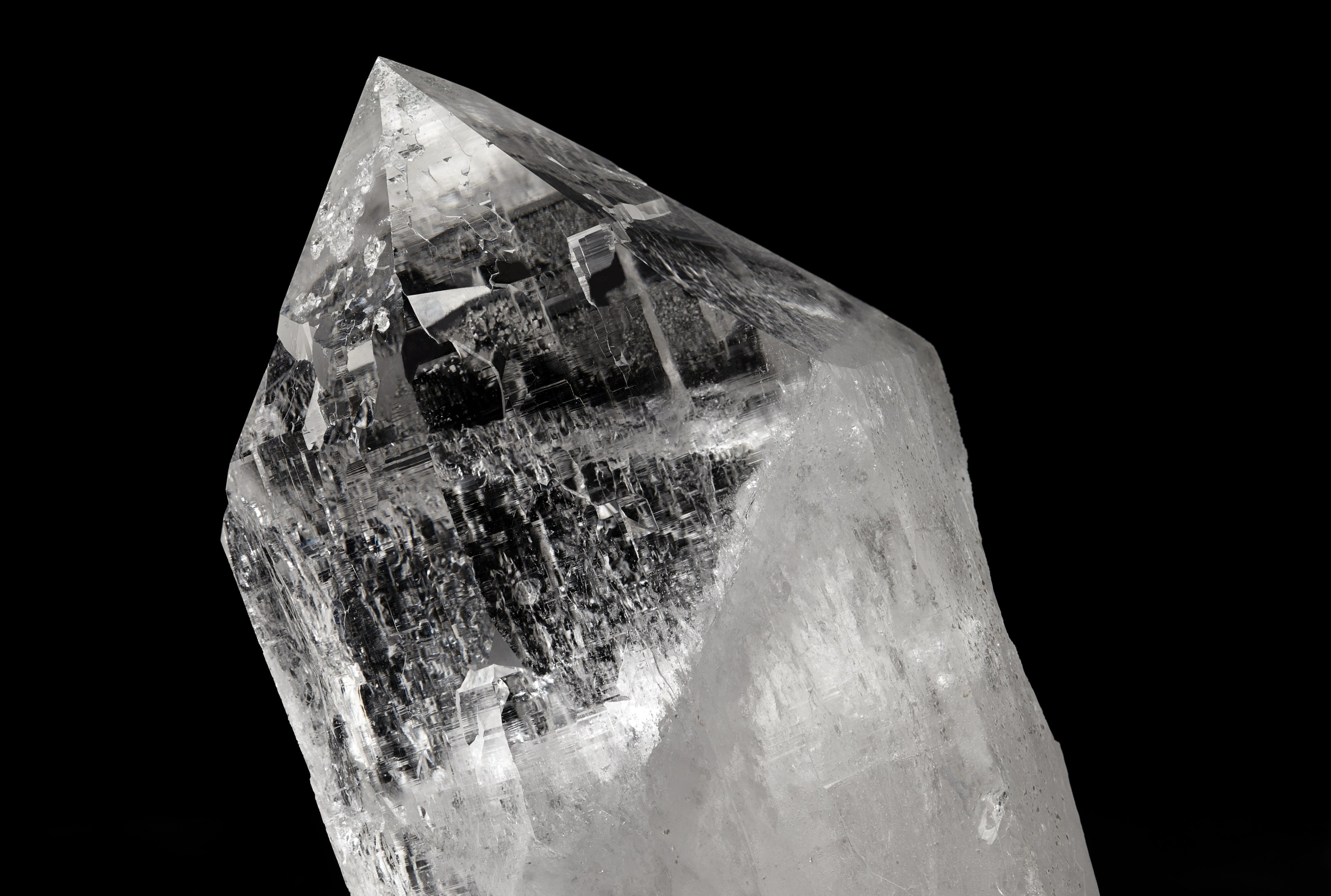 Clear quartz point on a black background