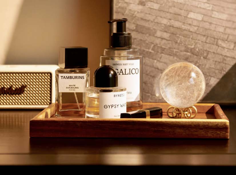 Crystal sphere and ritual oils arranged on a wooden tray