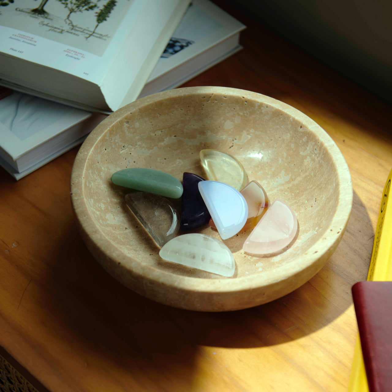Polished ritual stones arranged in a gold bowl