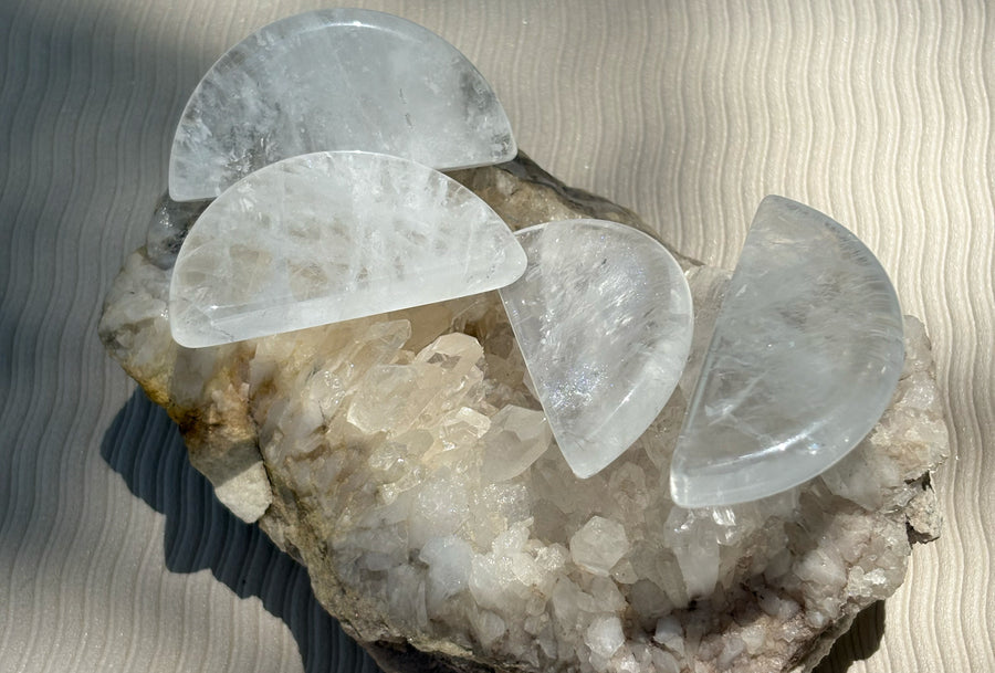 Clear quartz shapes arranged on a crystal cluster