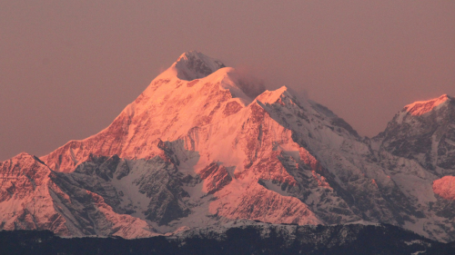 Snowy Himalayan mountains glowing at sunset