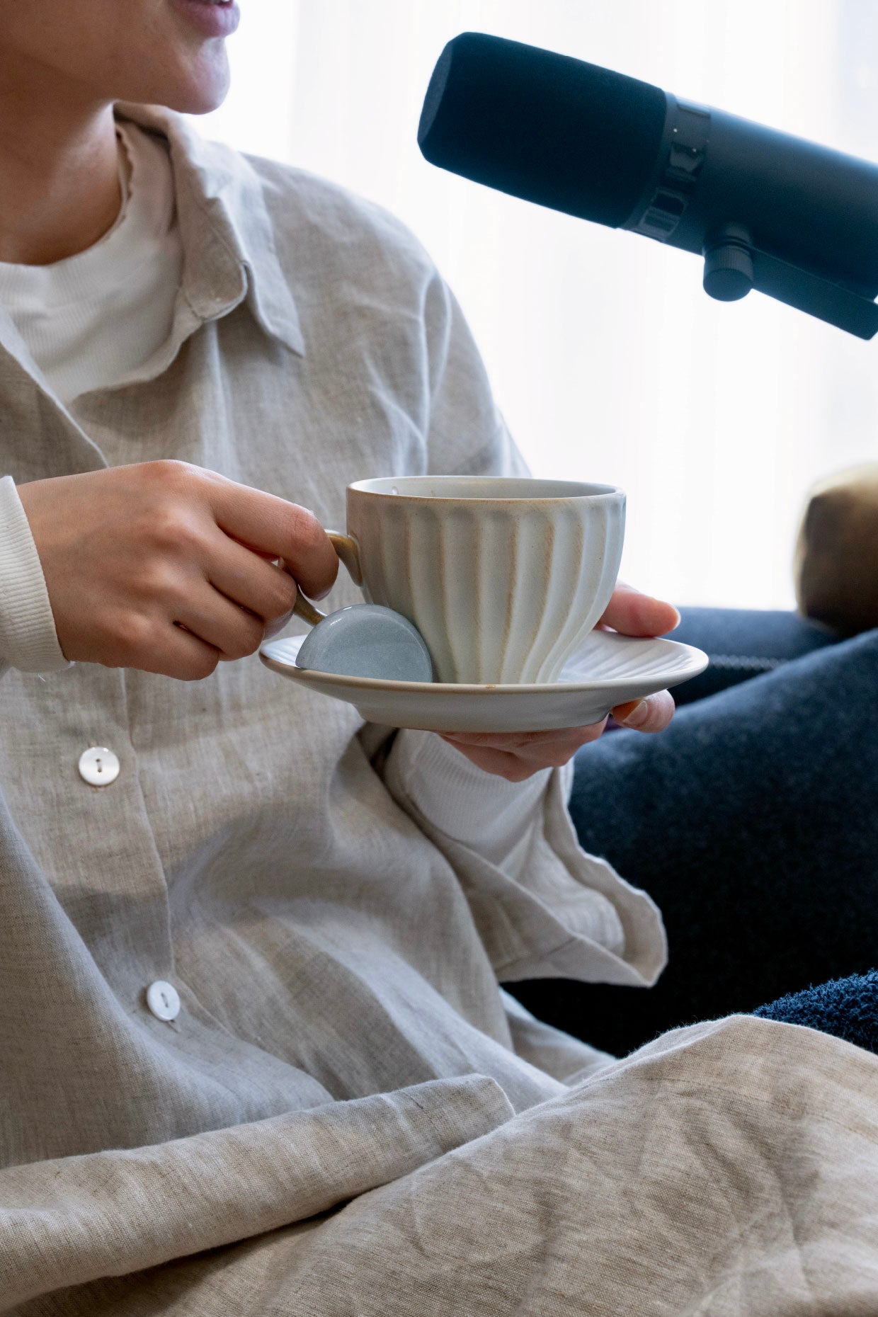 Woman drinking tea while seated on a sofa