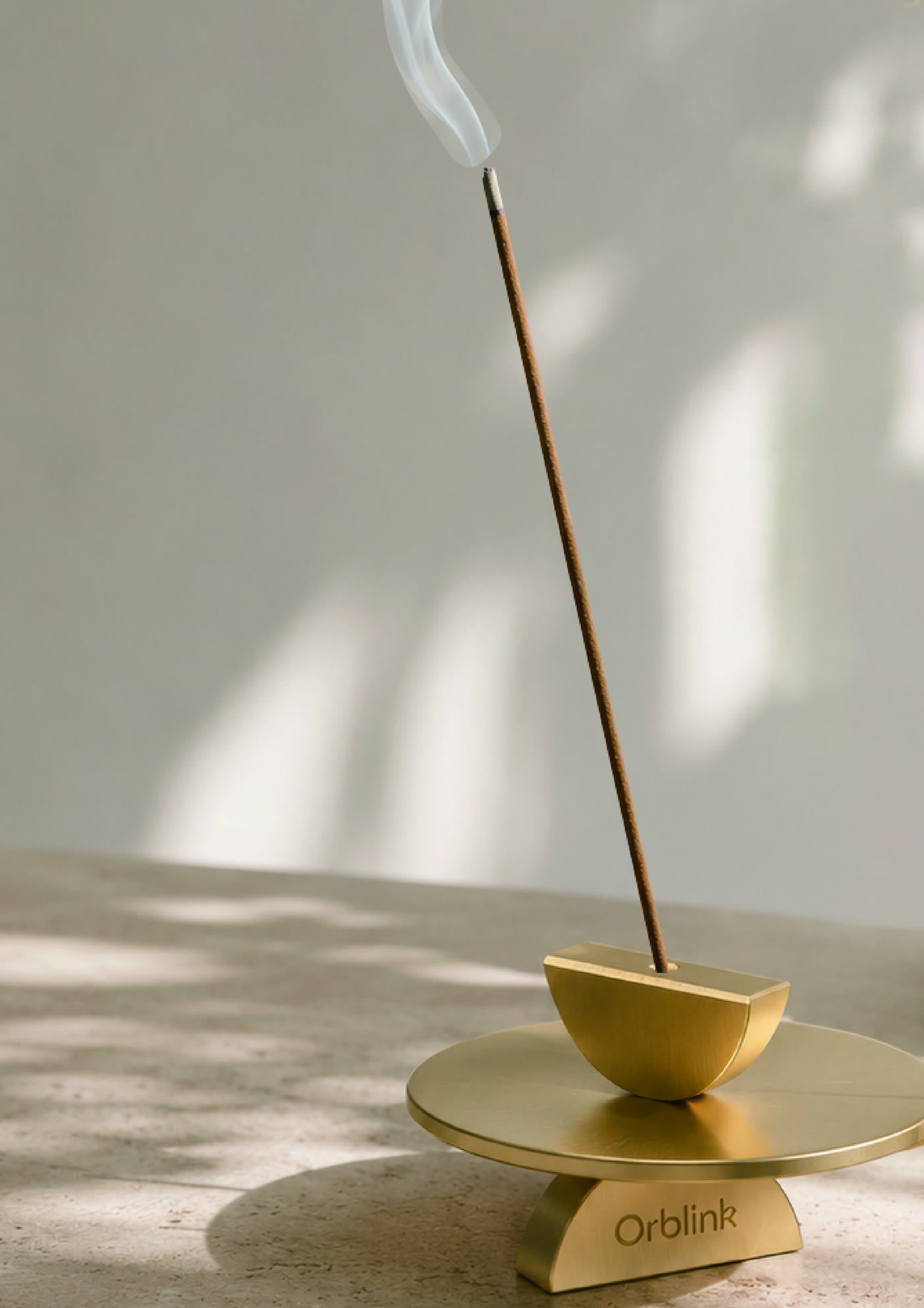 Orblink brass incense holder with a lit incense stick